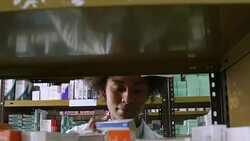 Pharmacist examining medicines on rack in pharmacy Stock Footage