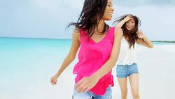 African American Asian Chinese female on ocean beach Stock Footage