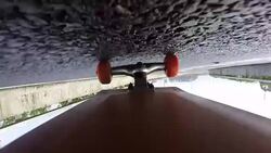 Under skateboard upside down POV - A person skating on a highway road Stock Footage
