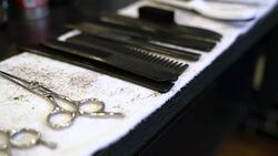 Haircutting scissors and combs on napkin Stock Footage
