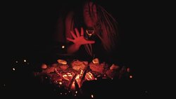 Scary witch does voodoo black magic ritual near the fire at night. Halloween horror Stock Footage