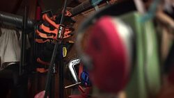 Clamps hanging from a rail are taken down in a workshop. Stock Footage