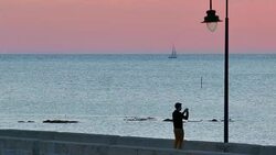 Wide Angle: Man Taking Pictures at Dusk Stock Footage