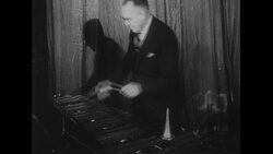 Australia, c.1951: Students eagerly listen as percussion instruments are struck by musicians Stock Footage