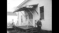 United States, 1950s: Boy walks out of post office Stock Footage