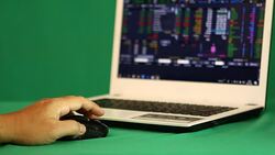 Using laptop  trading  stock exchange Stock Footage