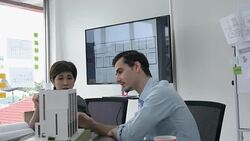 Architects male and Businesswoman are working on a building model. Business woman suggest idea to designer at modern office. concept of construction, architecture, development and creative. Stock Footage