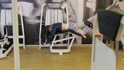 Girl doing exercise for legs on a press machine in the gym. Stock Footage