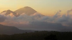 Moving clouds at sunrise around Mount Agung in Bali Stock Footage