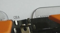 Close up footage of a person writing CHAPTER II on an old typewriter, with sound... Stock Footage