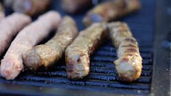 Cooking Kebabce. Balkan meatball barbeque on grill at local traditional festival Stock Footage