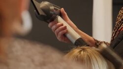 Hairdressers cutting hair in a salon News Clip