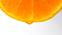 Drops of juice of a citrus on white background Stock Footage