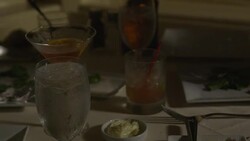 Martini, highball and ice water glasses on table Stock Footage