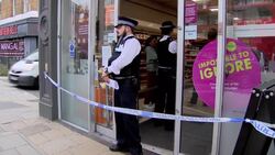 Police outside a closed Sainsbury's after alleged food contamination incident News Clip