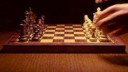 chess player making a move in the game on wooden table Stock Footage