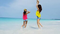Happy multi ethnic girlfriends on ocean beach vacation Stock Footage