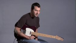 How to Hold a Guitar Properly While Sitting Instructional Video