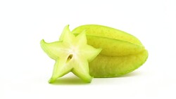 One whole and one half of carambola fruit with water drops. Slowly rotating on the turntable isolated on the white background. Close up. Macro. Stock Footage