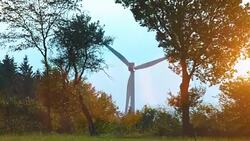 Wind turbines and agricultural fields on a summer day Stock Footage