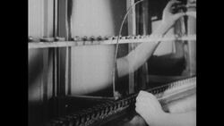 United States, 1930s-1940s: Hot glass exits a furnace through a roller Stock Footage