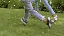 Two little friends running on grass in garden Stock Footage