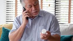 Senior man looking to medicine in hand. Man talking with doctor about medicine in hand. People with healthcare, medical concept. Stock Footage