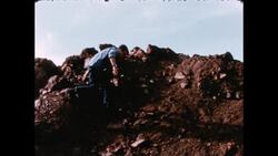 1970s: Boy climbs rock Stock Footage