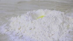 Egg dropping onto flour Stock Footage
