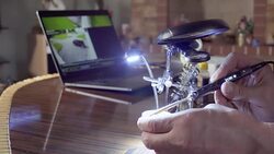 Hand is soldering the part under the magnifying glass. Stock Footage