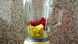 Filling in the blender of apples, raspberry and bananas.	Preparation of smoothie in the blender. Stock Footage