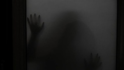 Spooky silhouette of ghost woman behind the matte glass window Stock Footage