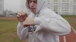 Man in hoodie boxing with invisible opponent at stadium. Young man training Stock Footage