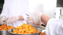 hands pastry chef cutting apricots, prepare the jam in industrial kitchen worktop Stock Footage