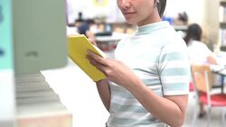 Woman reading book at library Stock Footage