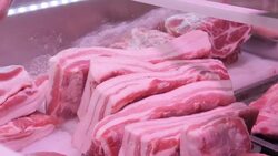 Butchers serving customers at a Beijing meat market News Clip