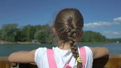 Little girl admiring the coastline of aboard a boat Stock Footage