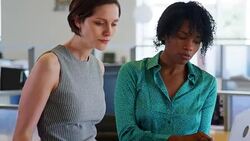 Two female architects discussing design plans, close up Stock Footage