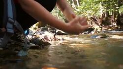 Woman hands washing in the cold water of the river. Stock Footage