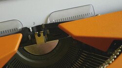 High and side angle footage of a person writing DISEASE on an old typewriter, with sound Stock Footage