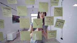 Woman writing message on adhesive note Stock Footage