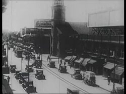 Busy streets of Manhattan, Times Square, traffic, rush hour pedestrians, fashionable high society, possibly at entrance to a theatre, c.1920 Stock Footage