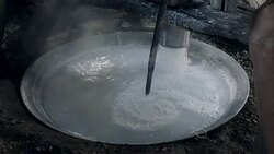 Traditional making of rice noodles using pressing machine to cut rice dough into strips Stock Footage