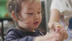 Happy Asian baby girl eating food at home. feed by her mom. Concept : Food,Family,life. Stock Footage