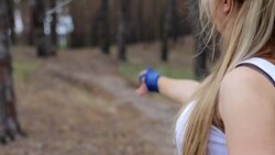 Girl throws knives at the target Stock Footage