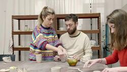 Teacher and student talking while working on clay Stock Footage