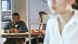 Young Multiethnic Colleagues Talking in Office Late Stock Footage