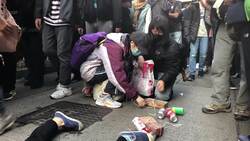 Woman protests by crawling on her hands and knees News Clip