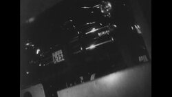 United States, c.1951: An automobile is brought to the top floor of a parking garage and parked by an automated machine Stock Footage