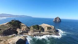 Ocean cliff coastline with Haystack Rock Stock Footage